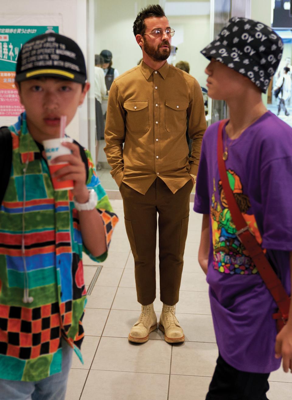 <cite class="credit">Shirt, $98, by Michael Kors / Pants, $450, by 3.1 Phillip Lim / His own boots, by R13 / Watch, his own / Glasses, his own, by Garret Leight | Location: Tokyo Station</cite>