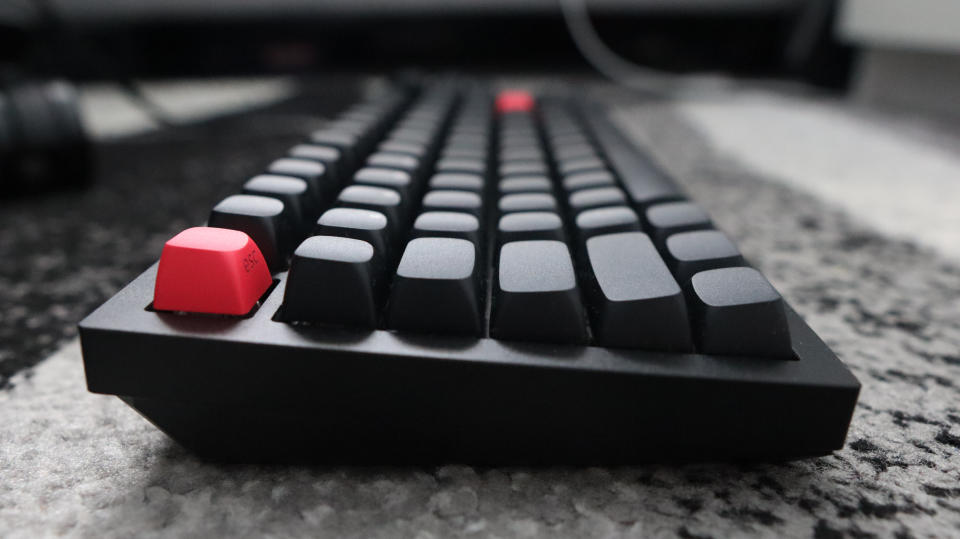 The Keychron Q3 Max gaming keyboard set-up on a desk with the RGB lighting enabled.