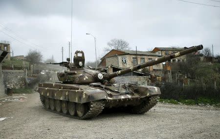 A tank of the self-defense army of Nagorno-Karabakh moves on the road in the village of Talish April 6, 2016. REUTERS/Staff