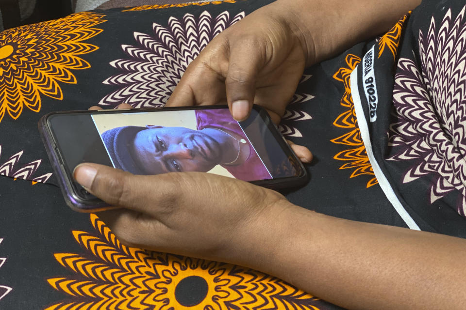 FILE - In this Friday, March 5, 2021 file photo, Anifa holds her phone displaying a photo of former World Health Organization doctor Boubacar Diallo of Canada, during an interview in the eastern Congo town of Goma. A panel commissioned by the World Health Organization on Tuesday Sept, 28, 2021 identified more than 80 alleged cases of sex abuse during the U.N. health agency's response to an Ebola outbreak in Congo, including allegations implicating 20 WHO staff members. (AP Photo/Kudra Maliro, File)