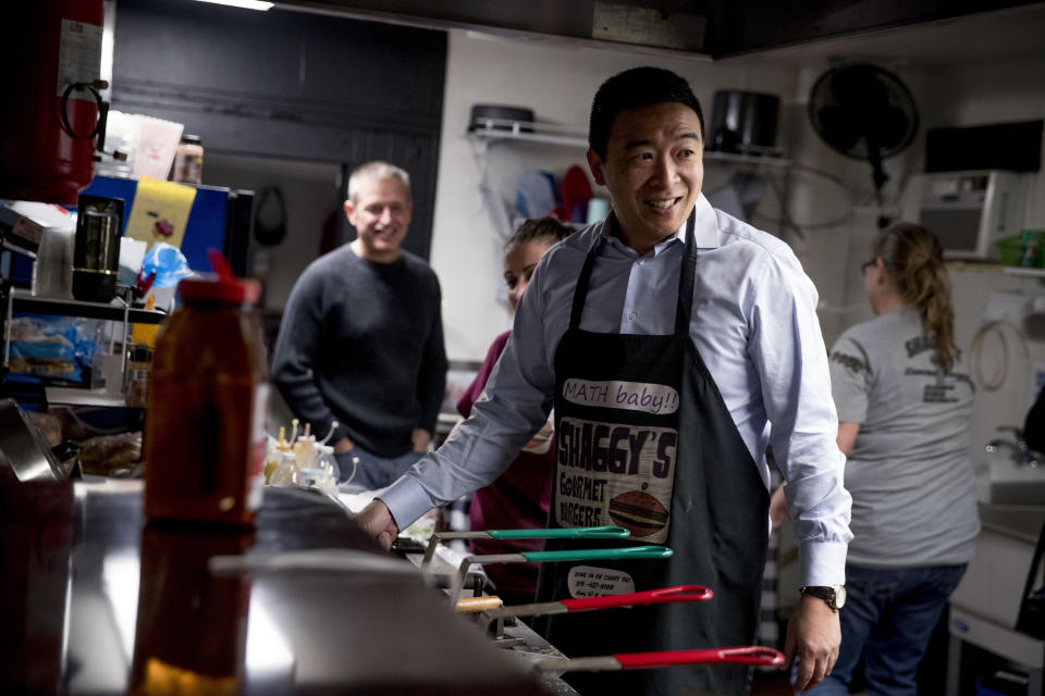 FILE - In this Jan. 4, 2020, file photo, Democratic presidential candidate Andrew Yang smiles as he flips hamburgers at a campaign stop at Shaggy's Gourmet Burgers, in Wapello, Iowa. After months of running as a non-politician with unconventional campaign strategies and novel ideas, Andrew Yang has reached the point where he needs to be seen as a serious candidate with a chance of beating President Donald Trump. (AP Photo/Andrew Harnik)