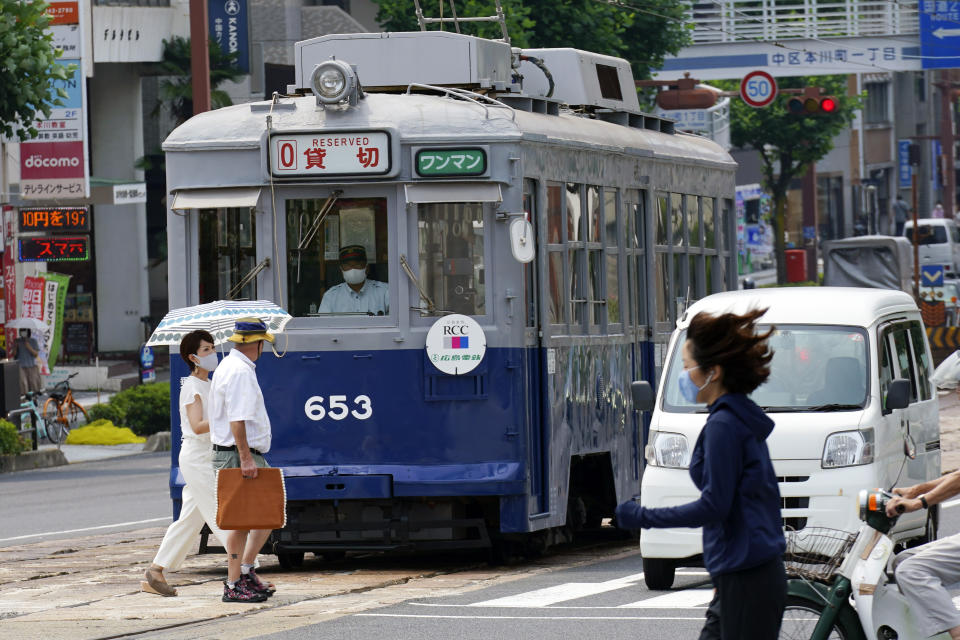 The No. 653 tram, which survived the atomic bomb, runs along the street near the Atomic Bomb Dome to commemorate the 75th anniversary of the U.S. first atomic bombing on the city in Hiroshima, Japan, Thursday, Aug. 6, 2020. (AP Photo/Eugene Hoshiko)