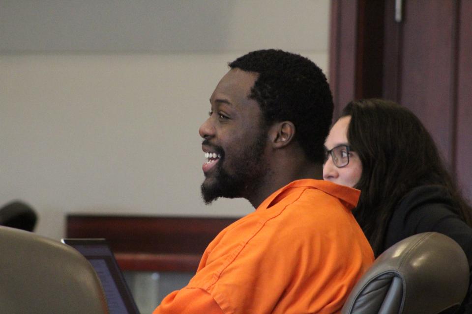 Kwentel Moultrie, sitting next to one of his public defenders, laughs at a comment his aunt made during his sentencing on Wednesday at the Kim C. Hammond Justice Center in Bunnell. Moultrie's family asked the judge for mercy for him.