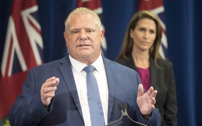 Ontario Premier Doug Ford, seen here in Toronto on Aug. 9, 2018, with Ontario Attorney General Caroline Mulroney in the background, had threatened to use the notwithstanding clause to push Bill 5 into law. Photo from The Canadian Press.
