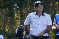 Patrick Reed smiles as he waits to tee off on the third hole during the first round of the American Express golf tournament at La Quinta Country Club Thursday, Jan. 20, 2022, in La Quinta, Calif. (AP Photo/Marcio Jose Sanchez)