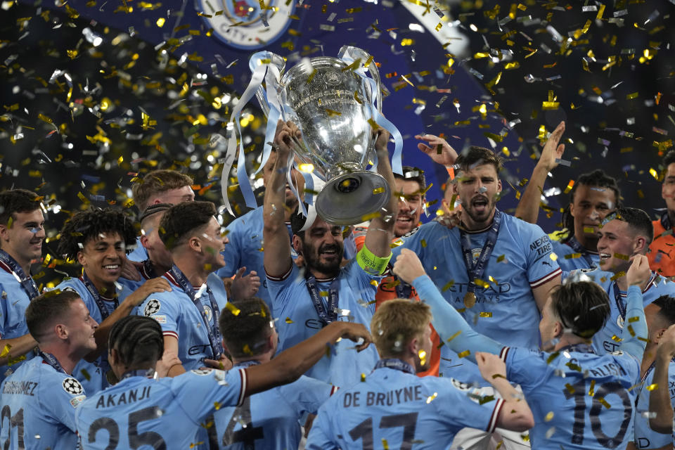 Manchester City's Ilkay Gundogan holds up the trophy after winning the Champions League final soccer match between Manchester City and Inter Milan at the Ataturk Olympic Stadium in Istanbul, Turkey, Sunday, June 11, 2023. Manchester City defeated Inter Milan 1-0. (AP Photo/Antonio Calanni)