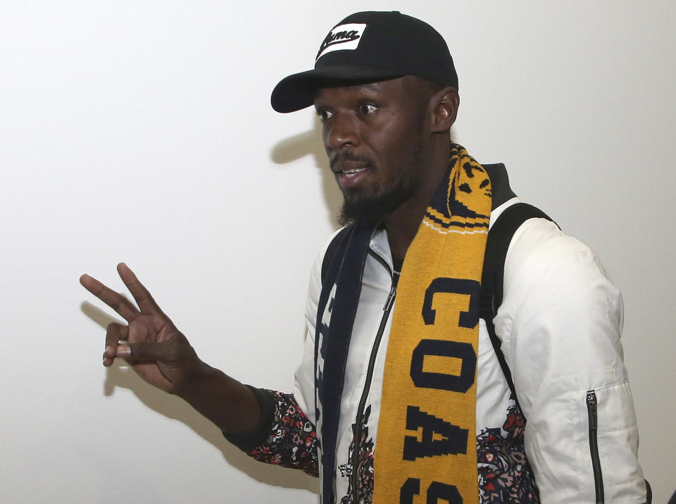 Jamaica's Usain Bolt waves as he arrives in Sydney, Saturday, Aug. 18, 2018. Olympic gold medalist sprinter, Bolt is hoping to impress the coaching staff enough to earn a contract with the Central Coast Mariners for the 2018-19 season in Australia's top-flight soccer competition.(AP Photo/Rick Rycroft)