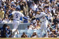 Los Angeles Dodgers' Shohei Ohtani (17) celebrates with Freddie Freeman (5) after they score on a two-run double by Will Smith during the fifth inning of a baseball game against the New York Mets in Los Angeles, Sunday, April 21, 2024. (AP Photo/Kyusung Gong)