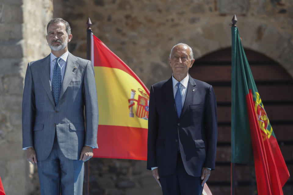 Spain's King Felipe VI, left, and Portugal's President Marcelo Rebelo de Sousa adjust their face masks during a ceremony to mark the reopening of the Portugal/Spain border in Elvas, Portugal, Wednesday, July 1, 2020. The border was closed for three and a half months due to the coronavirus pandemic. (AP Photo/Armando Franca)
