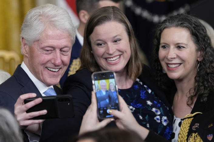 Former President Bill Clinton poses for a photo after an event with President Joe Biden and Vice President Kamala Harris in the East Room of the White House in Washington, Thursday, Feb. 2, 2023, to mark the 30thAnniversary of the Family and Medical Leave Act. (AP Photo/Susan Walsh)
