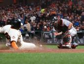 Jun 19, 2018; San Francisco, CA, USA; San Francisco Giants third baseman Pablo Sandoval (48) slides safely home against Miami Marlins catcher J.T. Realmuto (11) during the fifth inning at AT&T Park. Mandatory Credit: Kelley L Cox-USA TODAY Sports