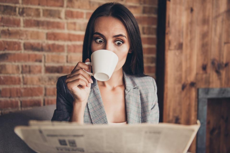 Shocked investor reading the newspaper.