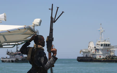 A maritime policeman on a tag-boat guards oil tanker Aris-13, which was released by pirates, as it sails to dock on the shores of the Gulf of Aden in the city of Bosasso, northern Somalia's semi-autonomous region of Puntland, March 19, 2017. REUTERS/Abdiqani Hassan FOR EDITORIAL USE ONLY. NO RESALES. NO ARCHIVES