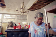 <p>Florida City, Fla., resident Doloris Clark, 74, refuses to leave her home which was badly damaged by Hurricane Andrew, fearing that thieves would take her remaining belongings, Sept. 6, 1992. A bust of Christ sits in the background. (AP Photo/John Moore) </p>