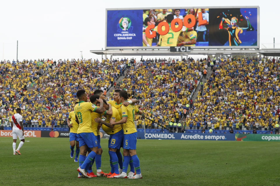 Teammates greet Brazil's Everton (19) for scoring his side's third goal against Peru during a Copa America Group A soccer match at the Arena Corinthians in Sao Paulo, Brazil, Saturday, June 22, 2019. (AP Photo/Victor R. Caivano)