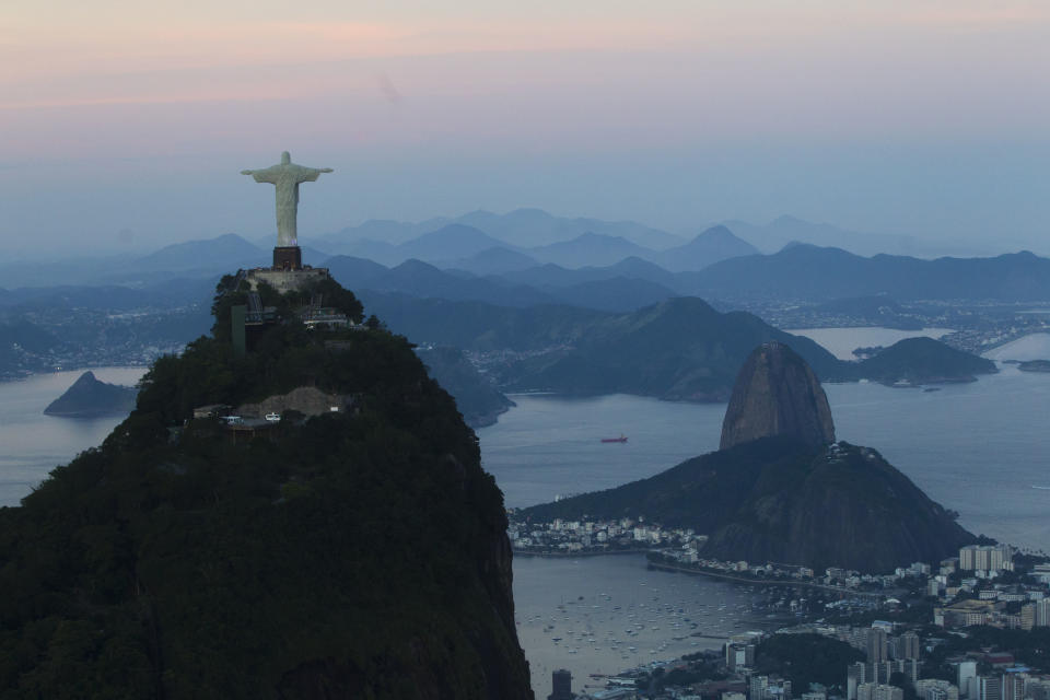 FILE - In this May 10, 2012 file photo, the Christ the Redeemer statue stands back dropped by Sugar Loaf mountain, right, as the sun sets in Rio de Janeiro, Brazil. For more than a decade, Brazil has been one of the developing world's great hopes, outpacing the growth of Western Europe and the U.S. Many even predicted it would soon become an economic superpower, but now analysts generally believe the big boom is past. (AP Photo/Felipe Dana, File)