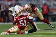 New Orleans Saints tight end Adam Trautman, middle, is tackled by San Francisco 49ers linebacker Azeez Al-Shaair (51) and linebacker Fred Warner (54) during the first half of an NFL football game in Santa Clara, Calif., Sunday, Nov. 27, 2022. (AP Photo/Jed Jacobsohn)