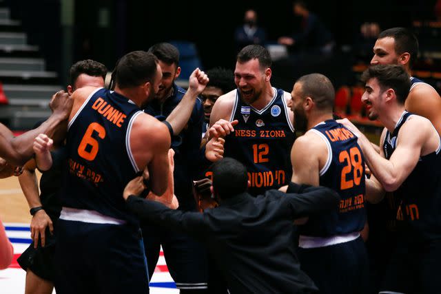 <p>Rene Nijhuis/BSR Agency/Getty</p> Uriel Trocki of Ironi Ness Ziona celebrates with his teammates during the Fiba Europe Cup