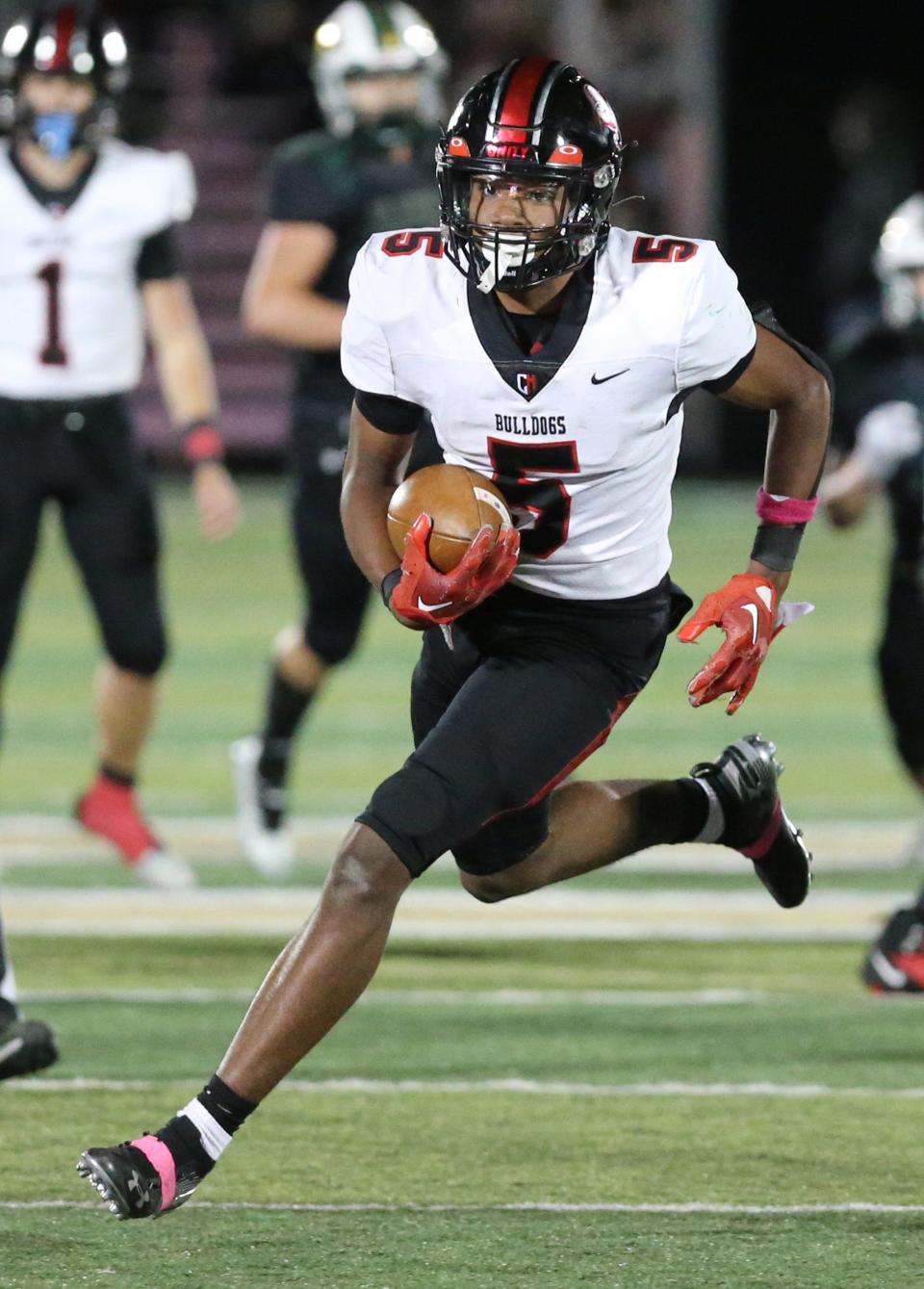 Dante McClellan of McKinley picks up yardage during their game at GlenOak on Friday, Oct. 14, 2022.