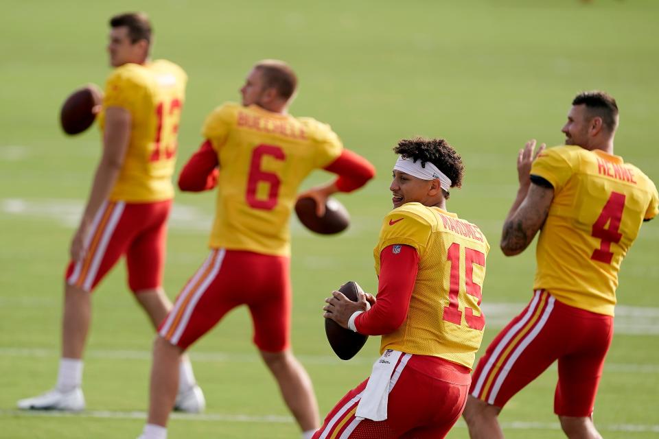 Kansas City Chiefs quarterbacks Dustin Crum (13), Shane Buechele (6), Patrick Mahomes (15) and Chad Henne (4) participate in a drill during NFL football training camp Aug. 7 in St. Joseph, Mo.