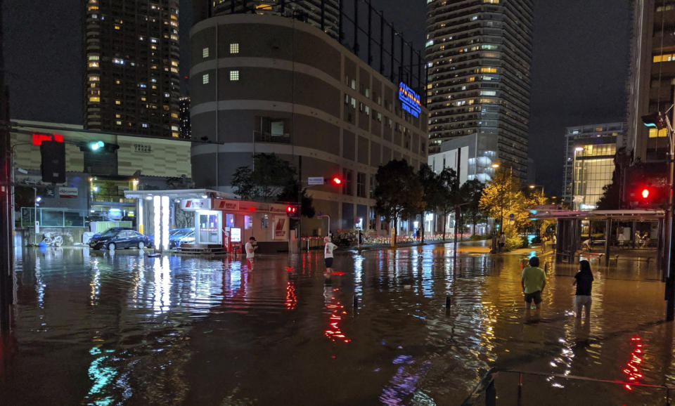 This Oct. 12, 2019 photo by @ar_kaz shows the flooded streets in Kawasaki, near Tokyo, Japan. Helicopters plucked people from their flooded homes on Sunday as rescue efforts went into full force in wide areas of Japan, including Tokyo, after a powerful typhoon unleashed heavy rainfall. (@ar_kaz via AP)