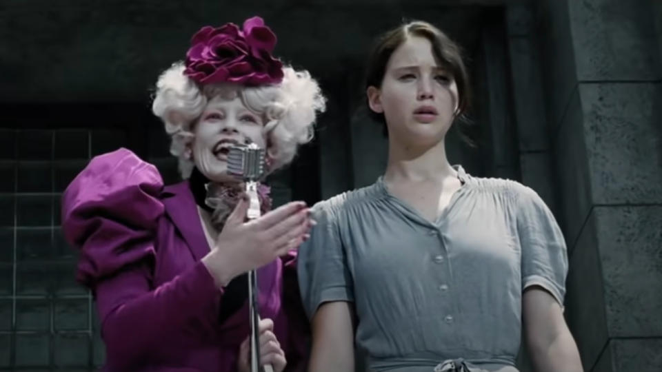 Elizabeth Banks presents a crying Jennifer Lawrence in The Hunger Games, pixelated.