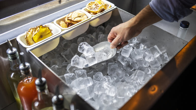 Person scooping ice with scooper