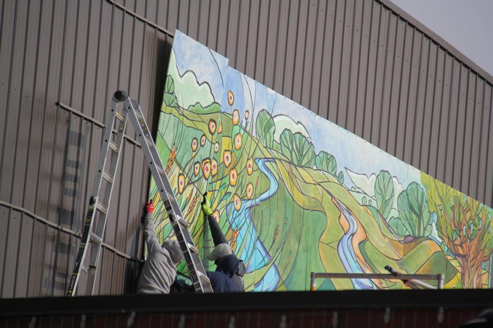 A new mural is installed above Raccoon Valley Bank on Tuesday, Nov. 7, 2023. A mural celebration will help kick off the Art on the Prairie weekend at 3 p.m. on Friday, Nov. 10 at Perry Perk.