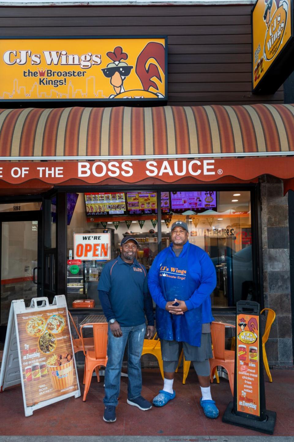 Cornelius Harrell Jr. and John Wyche outside of CJ's Wings.