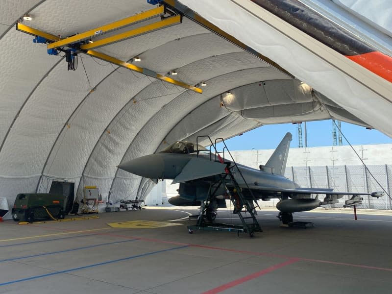 A Eurofighter, a German Air Force fighter plane, parks in a hangar. Alexander Welscher/dpa