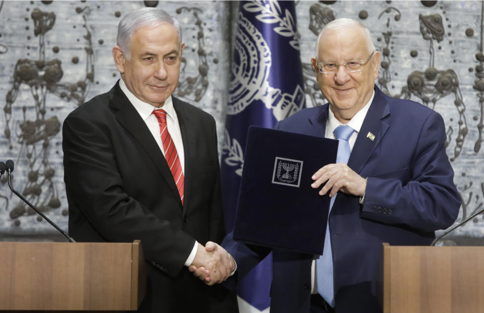 FILE - In this Wednesday, Sept. 25, 2109 file photo, Israeli President Reuven Rivlin, right, shakes hands with Israeli Prime Minister Benjamin Netanyahu in Jerusalem. For the sixth time in his lengthy political career, Netanyahu has been tasked by Israel’s president to form a new government. This time it’s no mere formality, but rather a daunting endeavor that looks like mission impossible. (AP Photo/Sebastian Scheiner, File)