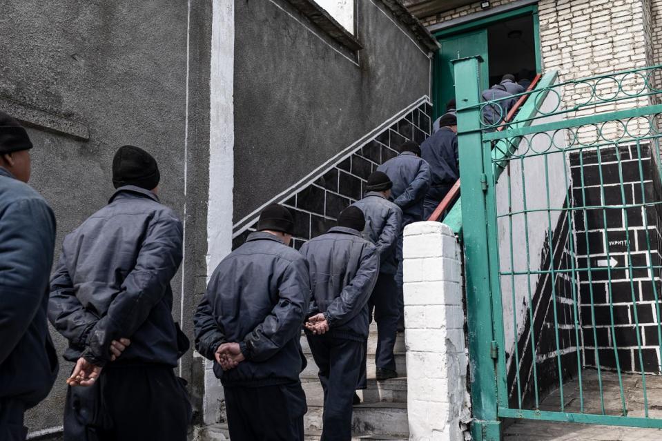 A group of Russian POWs lined up towards the stairs in a detention facility in western Ukraine on April 18, 2023. (Diego Herrera Carcedo/Anadolu Agency via Getty Images)