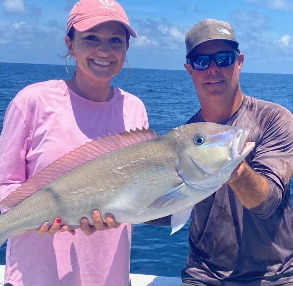 Kylie Leavens, visiting from Douglas, Ga., caught this blueline tilefish that weighed in at just under 14 pounds. Capt. Scott Housel (Sudden Strike Charter) lends a hand.