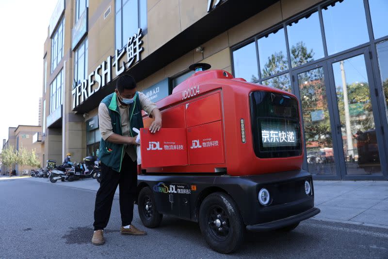 Autonomous delivery vehicle by JD Logistics operates on a street in Beijing