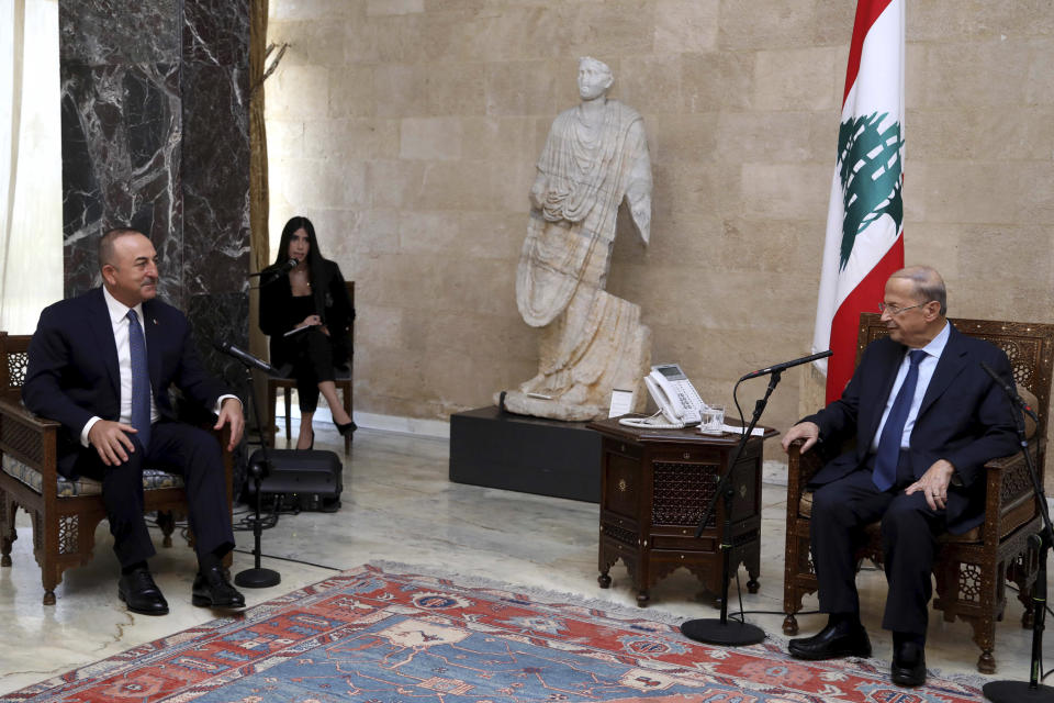 In this photo released by Lebanon's official government photographer Dalati Nohra, Lebanese President Michel Aoun, right, meets Turkey's Foreign Minister Mevlut Cavusoglu, at the presidential palace, in Baabda, east of Beirut, Lebanon, Tuesday, Nov. 16, 2021. Cavusoglu is in Beirut to meet and sign agreements with Lebanese officials. (Dalati Nohra via AP)