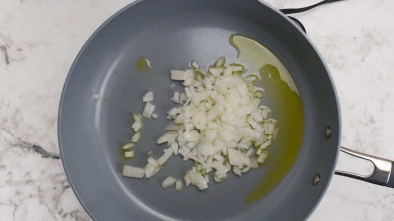 diced onion sautéing in pan 