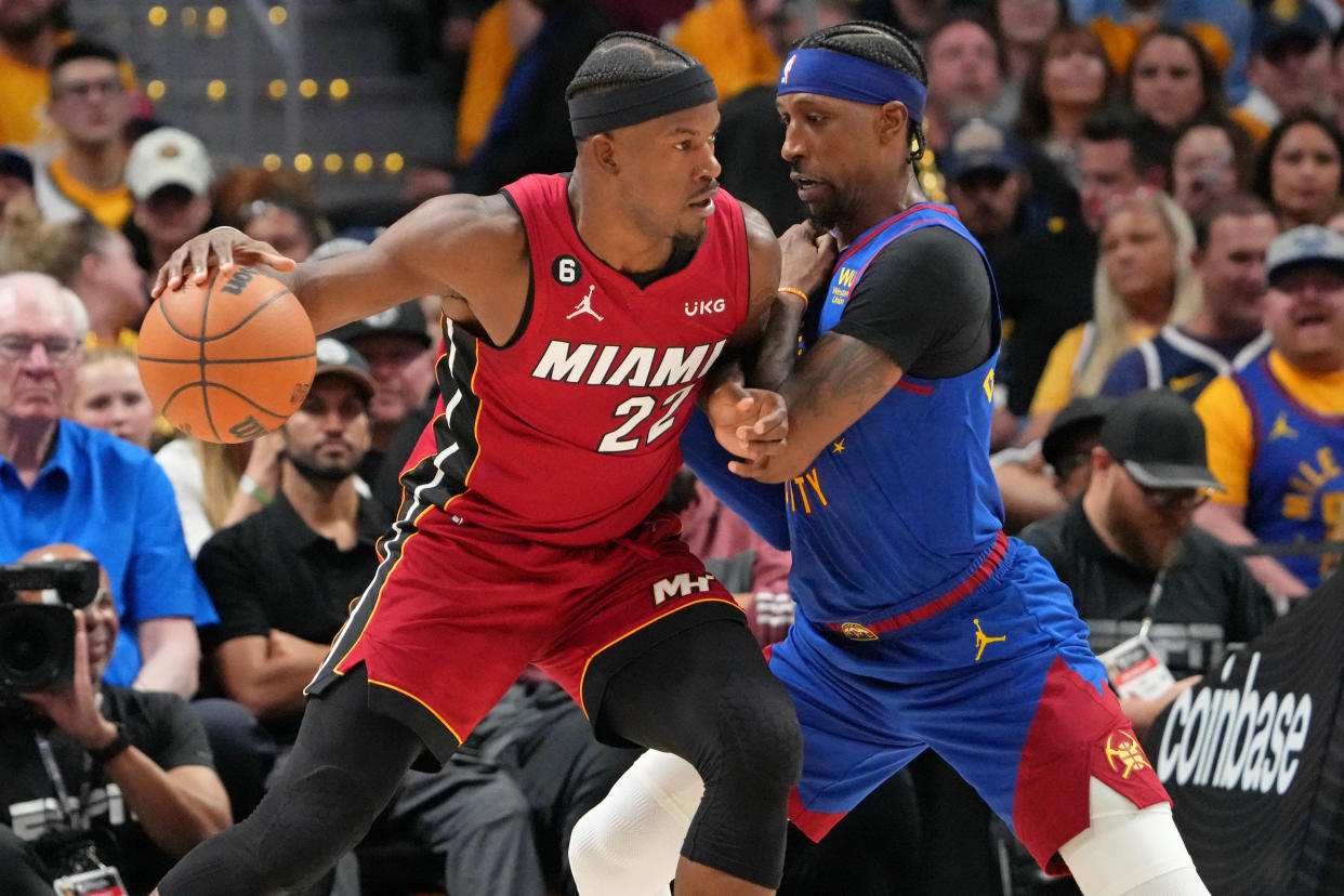 Miami Heat forward Jimmy Butler dribbles the ball against Denver Nuggets guard Kentavious Caldwell-Pope during Game 1 of the 2023 NBA Finals at Ball Arena in Denver on June 1, 2023. (Kyle Terada/USA TODAY Sports)