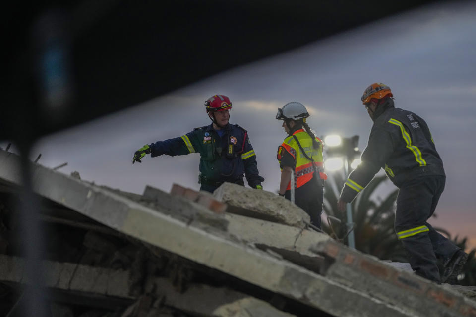 Rescue workers search the site of a building collapse in George, South Africa, Wednesday, May 8, 2024. Nearly 40 construction workers were still missing Wednesday in the rubble of a building that collapsed in South Africa on Monday as rescue teams continued to search for survivors for a third day in the wreckage of the unfinished five-story apartment complex. (AP Photo/Jerome Delay)