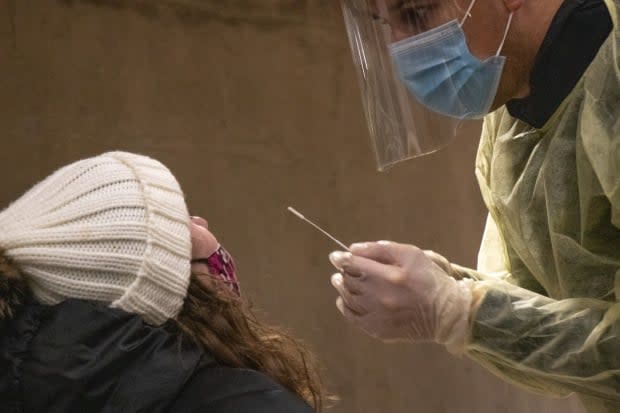 A worker administers a COVID-19 test at a rapid-testing event at Dalhousie University on Tuesday, Nov. 24. Nova Scotia announced seven new cases of the virus on Monday. (Robert Short/CBC - image credit)