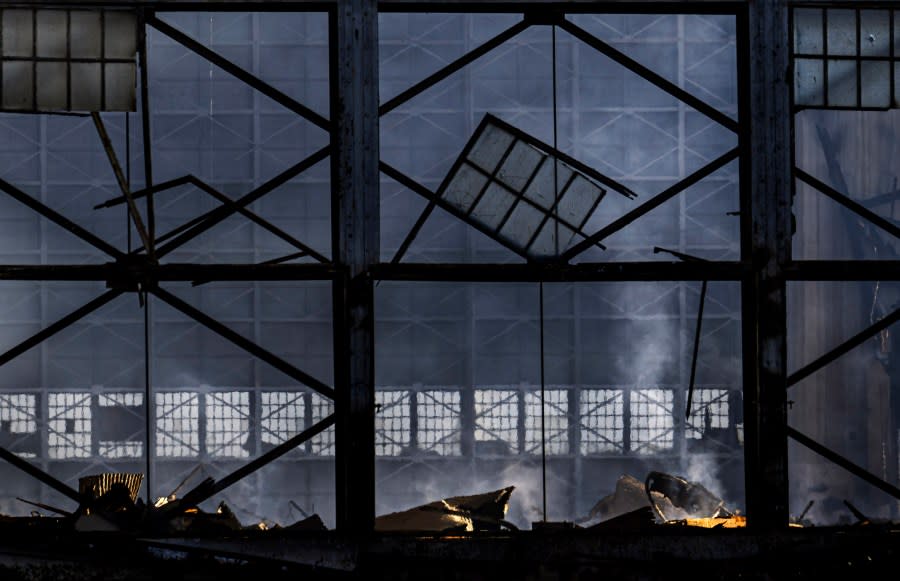 Smoke rises from the rubble of the historic Tustin Marine Corps Air Station blimp hangar, Wednesday, Nov. 8, 2023, in Tustin, Calif., the day after a fire destroyed the WWII-era structure. (Mindy Schauer/The Orange County Register via AP)