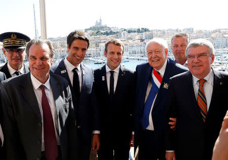 (L-R) Prefect of the region Provence-Alpes-Cote d'Azur Laurent Neyer, President of the region Provence-Alpes-Cote d'Azur Renaud Muselier, Co-Chairman of Paris 2024 Tony Estanguet, French President Emmanuel Macron, Mayor of Marseille Jean-Claude Gaudin and President of the International Olympic Committee (IOC) Thomas Bach after the press conference during their visit at the future site of the sailing for the 2024 Summer Olympic Games in Marseille, France, September 21, 2017. REUTERS/Sebastien Nogier/Pool