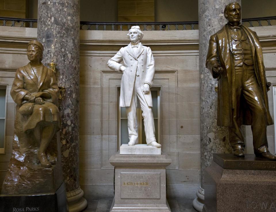 John Gorrie of Florida, inventor of the ice machine, stands next to the popular Rosa Parks, left, in Statuary Hall at the Capitol in Washington, Tuesday, July 2, 2013. A physician, scientist, and inventor, Gorrie is considered the father of refrigeration and air-conditioning; he died impoverished and virtually forgotten in 1855. Among the U.S. Capitol’s many statues which honor the nation’s founders, leaders and legends, the marble figure by scuptor C.A. Pillars, is largely overlooked by thousands of visitors who tour the Capitol daily. At right is Samuel Kirkwood who became famous as the governor of Iowa during the Civil War. (AP Photo/J. Scott Applewhite)