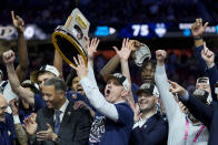 UConn head coach Dan Hurley celebrates with the trophy after their win against Purdue in the NCAA college Final Four championship basketball game, Monday, April 8, 2024, in Glendale, Ariz. (AP Photo/David J. Phillip)