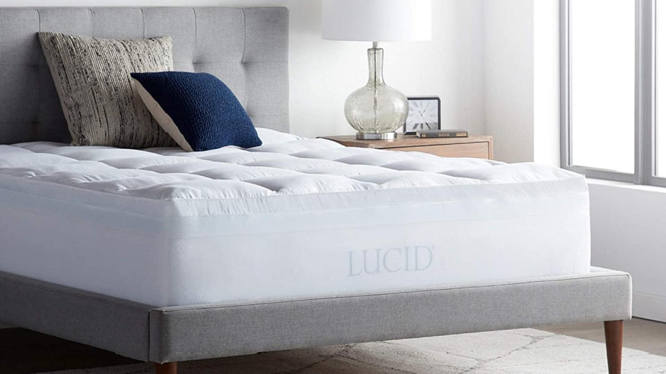 Best mattress toppers: The Lucid 4-inch Gel Memory Foam Mattress Topper on a wooden bed frame