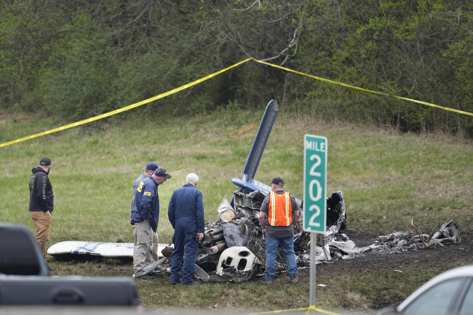 Investigators look over a small plane crash alongside eastbound Interstate 40 at mile marker 202 on Tuesday, March 5, 2024, in Nashville, Tenn. (AP Photo/George Walker IV)