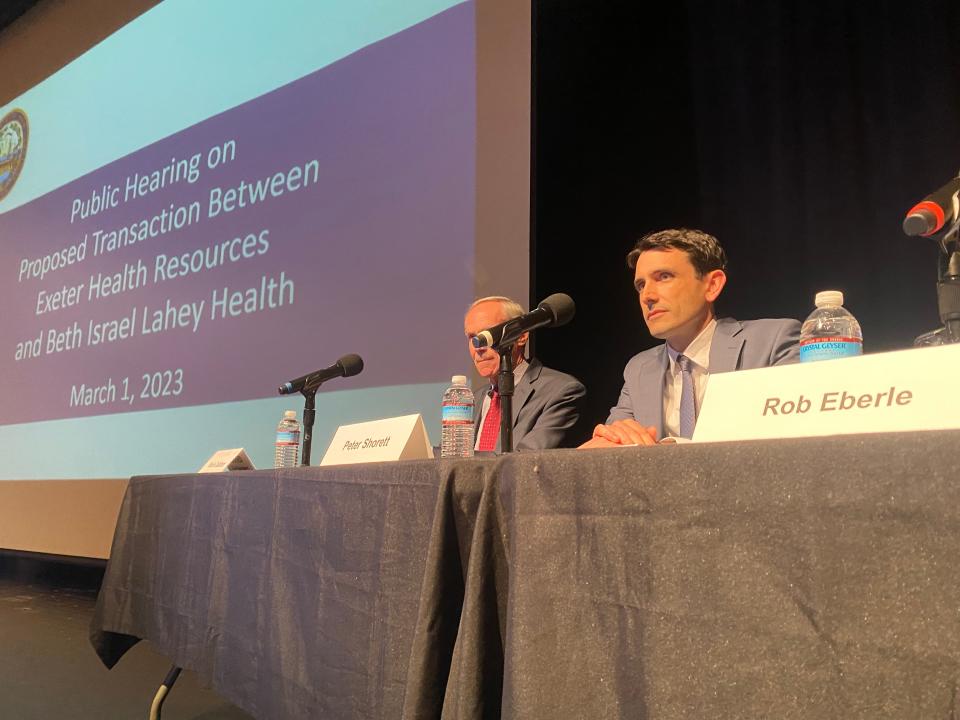 Peter Shorett (right), chief strategy officer of Beth Israel Lahey Health, and Kevin Callahan, president of Exeter Health Resources Inc., on a panel at Wednesday's public hearing on their proposed hospital merger.