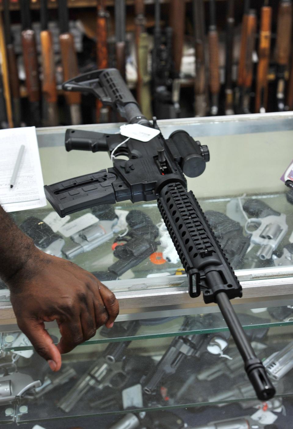 AR-15 style rifles like this one in a 2016 photo from a Jacksonville gun shop could be converted into fully automatic machine guns using the AutoKeyCard device that Orange Park resident Kristopher "Justin" Ervin was sentenced to 68 months in prison for manufacturing.