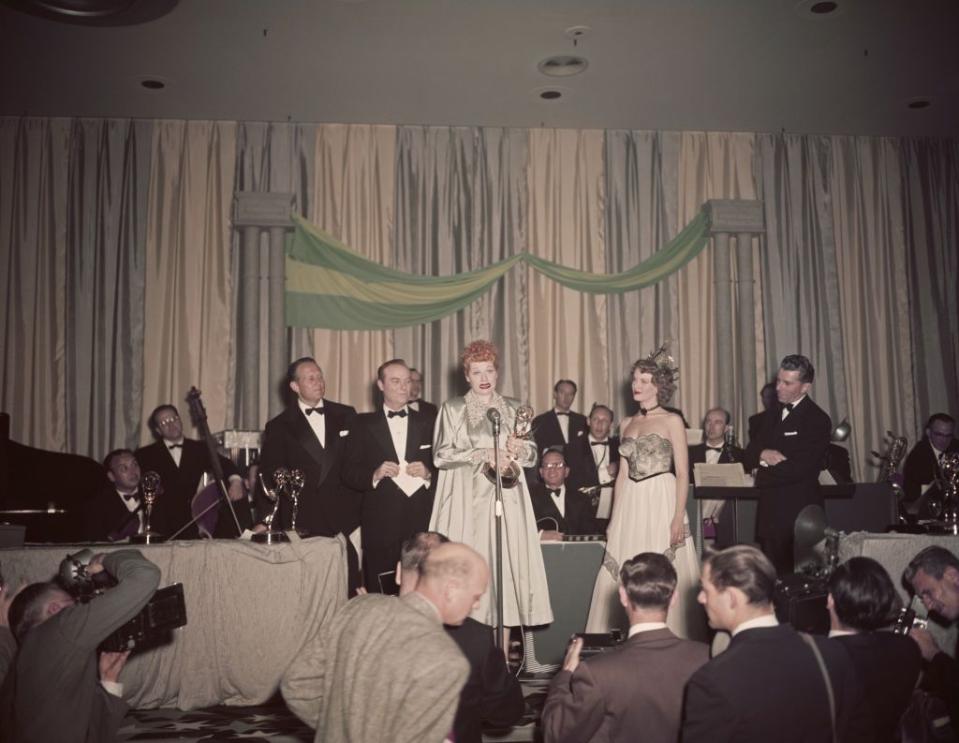 <p>Lucille Ball accepts the award for Best Comedienne for her work on <em>I Love Lucy</em>. The program was a television fixture throughout its six-season run from 1951–1957, and brought home four Emmys.</p>