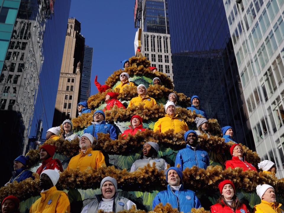 People sing carols in the Macy's Singing Christmas Tree on 6th Avenue during the Macy's Thanksgiving Day Parade in Manhattan, New York, U.S., November 23, 2017.