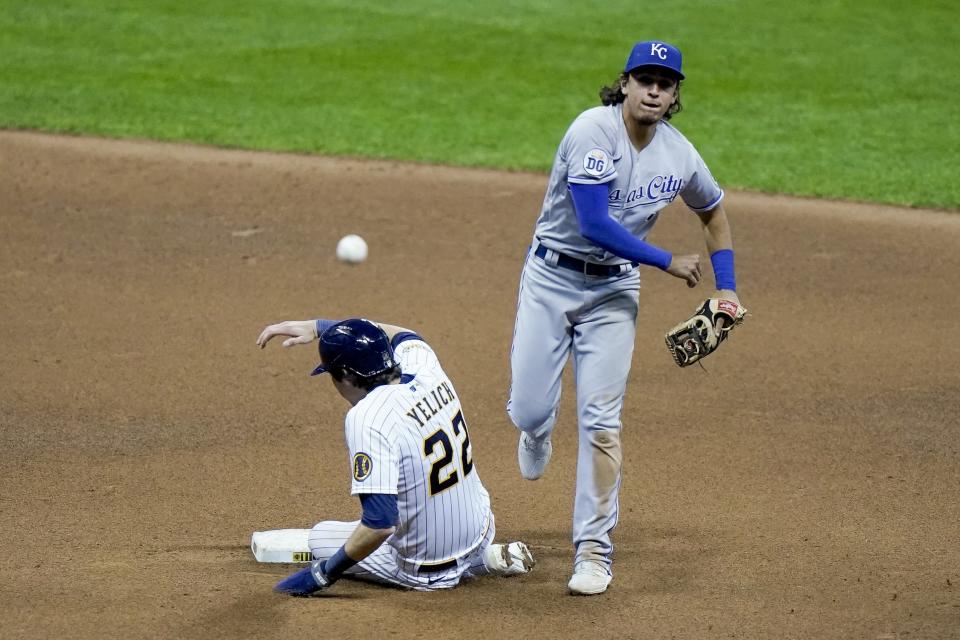 Milwaukee Brewers' Christian Yelich is out at second as Kansas City Royals' Nicky Lopez turns a double play on a ball hit by Ryan Braun during the sixth inning of a baseball game Saturday, Sept. 19, 2020, in Milwaukee. (AP Photo/Morry Gash)